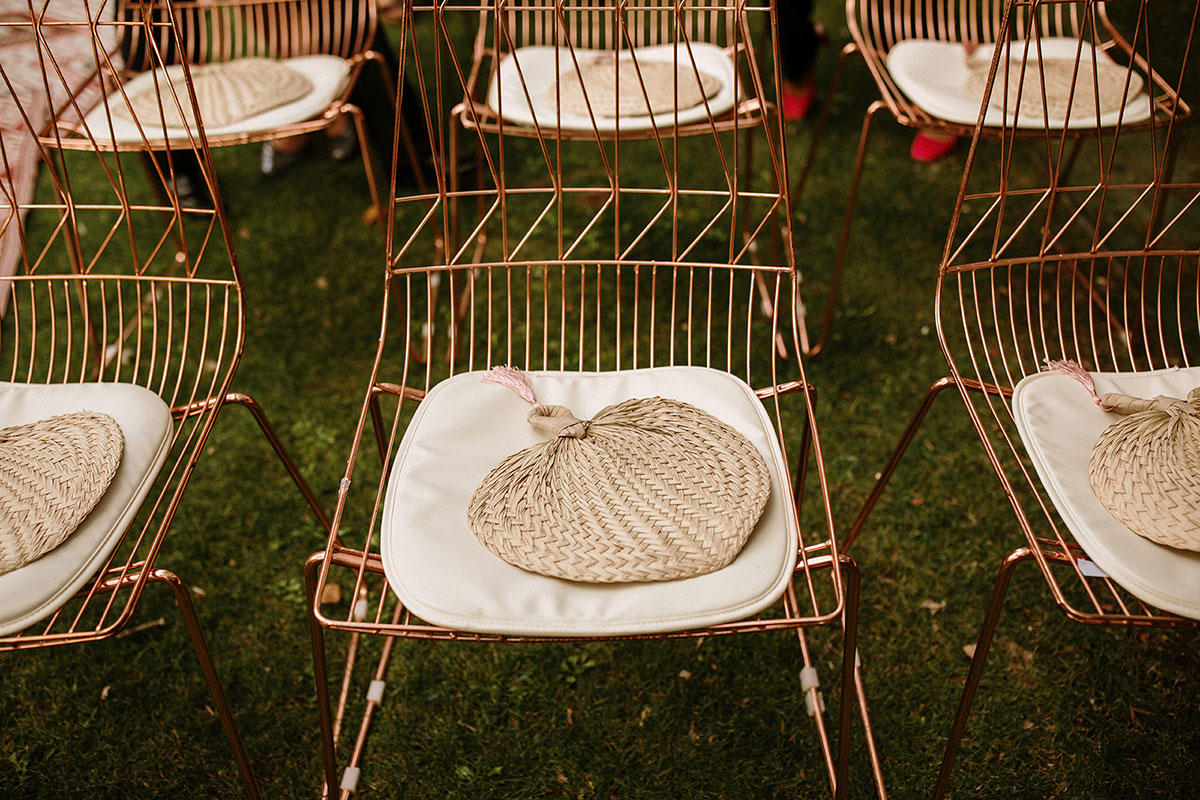 sillas de color cobre con almohada blanca y abanico paipai de mimbre | boda boho chic Bodas de cuento